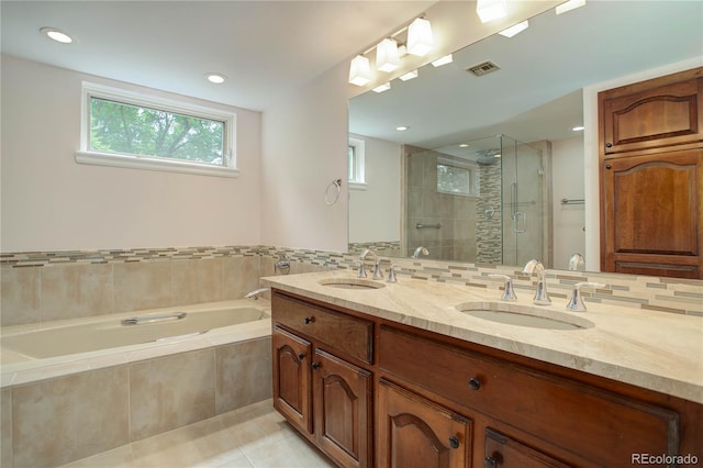 full bath with tile patterned flooring, a sink, visible vents, and a shower stall