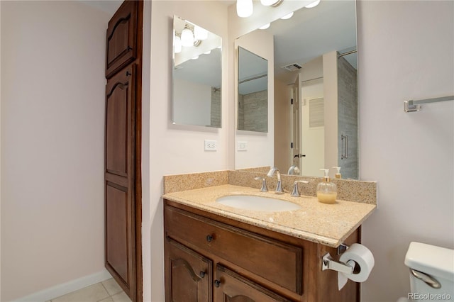 bathroom with toilet, tile patterned floors, visible vents, and vanity