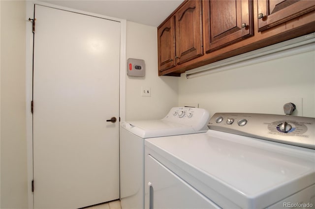 washroom featuring cabinet space and independent washer and dryer