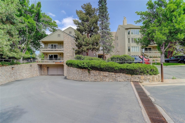 exterior space featuring a garage and aphalt driveway