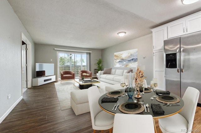 living room with dark wood-type flooring and a textured ceiling