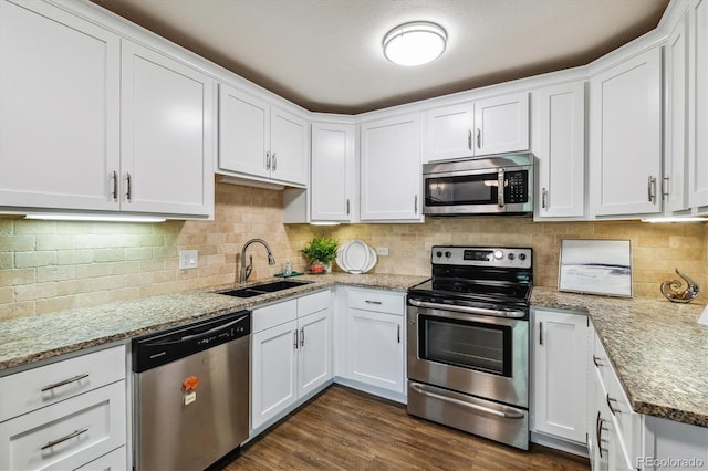 kitchen featuring light stone countertops, white cabinetry, stainless steel appliances, sink, and dark hardwood / wood-style floors