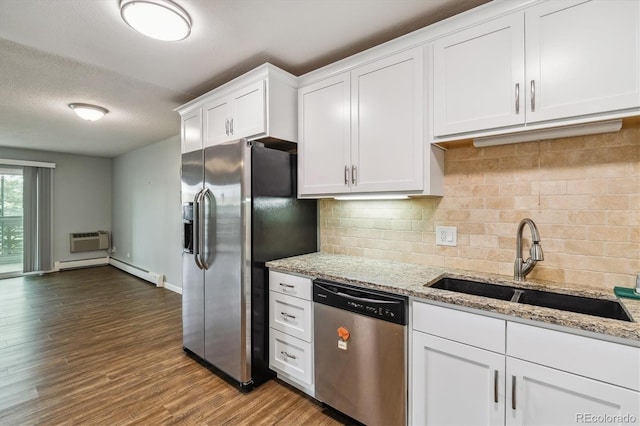 kitchen featuring sink, white cabinetry, light stone countertops, and appliances with stainless steel finishes