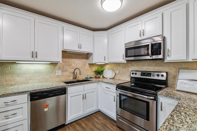 kitchen with sink, white cabinetry, light stone countertops, and stainless steel appliances