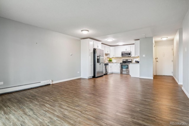 unfurnished living room featuring a baseboard heating unit, dark hardwood / wood-style flooring, and a textured ceiling