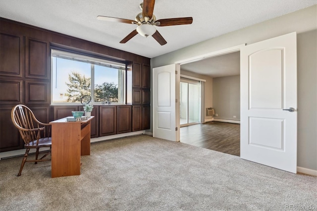 office space with ceiling fan, dark carpet, and a textured ceiling