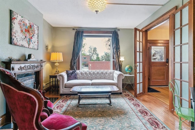 sitting room with french doors and wood finished floors