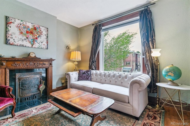 living area with wood finished floors and a premium fireplace