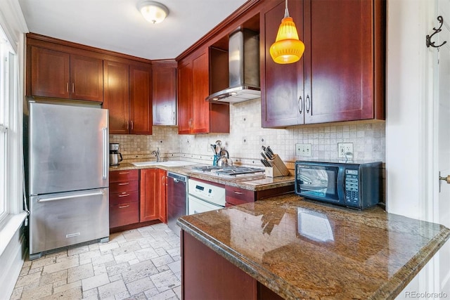 kitchen featuring wall chimney range hood, stainless steel appliances, reddish brown cabinets, and tasteful backsplash