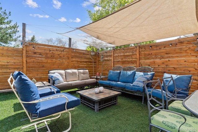 view of patio / terrace with an outdoor living space and a fenced backyard