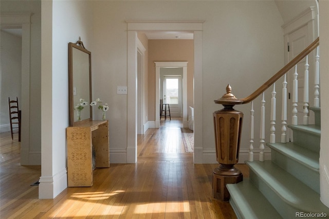 3330 Bruce Randolph Ave, Denver, CO 80205 - corridor featuring wood-type flooring, stairway, and baseboards