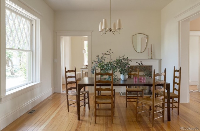 3330 Bruce Randolph Ave, Denver, CO 80205 - dining area with light wood finished floors and a chandelier