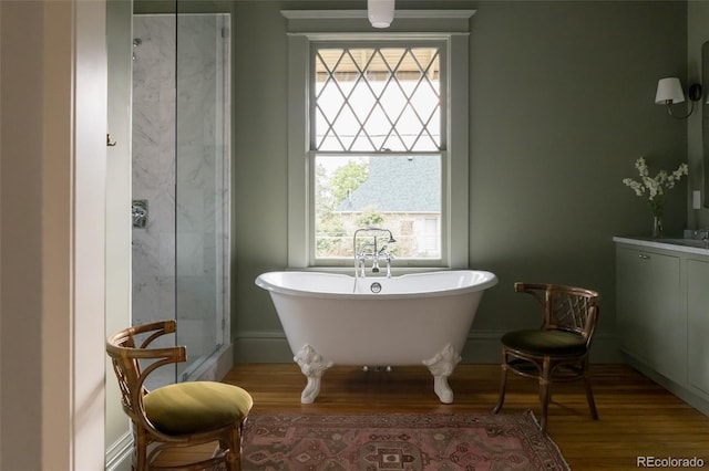 3330 Bruce Randolph Ave, Denver, CO 80205 - full bathroom with healthy amount of natural light, a freestanding tub, and wood finished floors