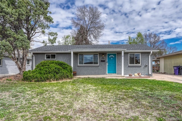 single story home with brick siding and a front lawn