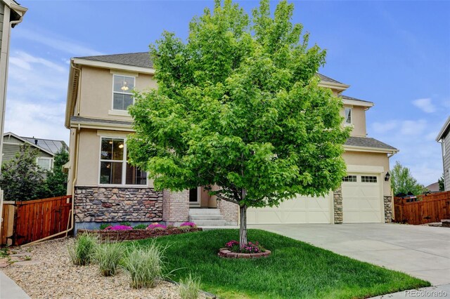 2454 Ambience Ln, Castle Rock, CO 80109 - view of property hidden behind natural elements with stucco siding, stone siding, concrete driveway, and an attached garage