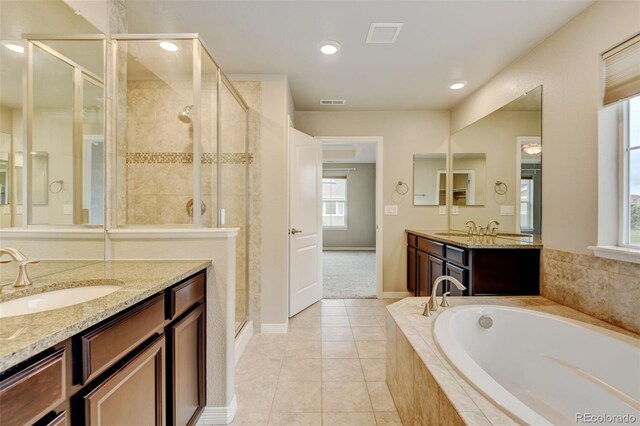 2454 Ambience Ln, Castle Rock, CO 80109 - bathroom with a bath, a shower stall, vanity, tile patterned floors, and baseboards
