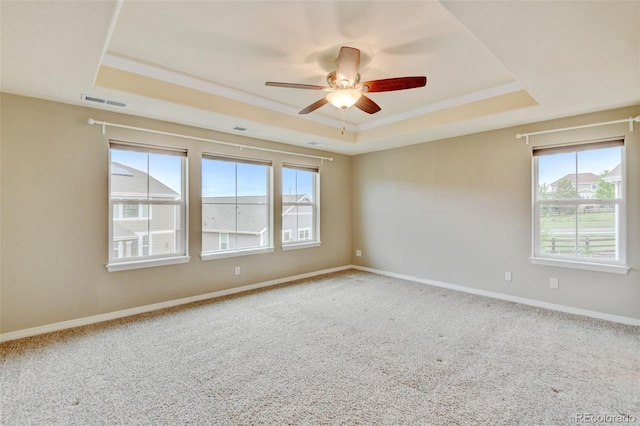 2454 Ambience Ln, Castle Rock, CO 80109 - spare room with a tray ceiling, a ceiling fan, carpet flooring, baseboards, and ornamental molding