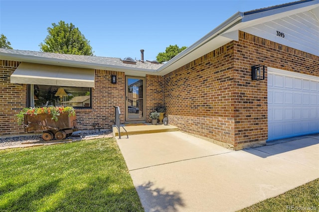 3245 S Kendall St, Denver, CO 80227 - entrance to property with brick siding, a garage, and a lawn