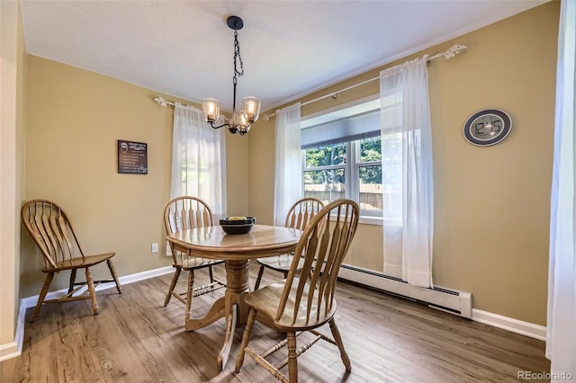 3245 S Kendall St, Denver, CO 80227 - dining area with a baseboard heating unit, wood finished floors, and a chandelier