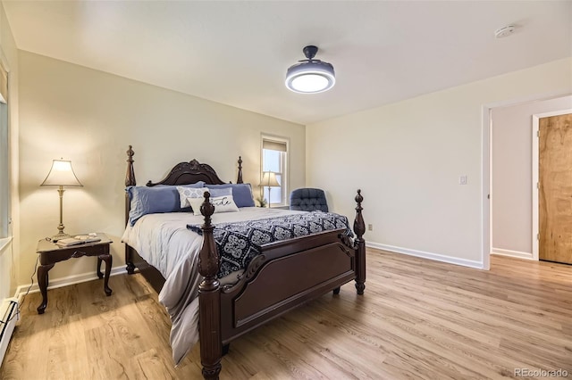 3245 S Kendall St, Denver, CO 80227 - bedroom featuring light wood-style floors and a baseboard heating unit
