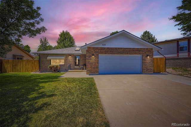 3245 S Kendall St, Denver, CO 80227 - ranch-style house featuring driveway, brick siding, and an attached garage