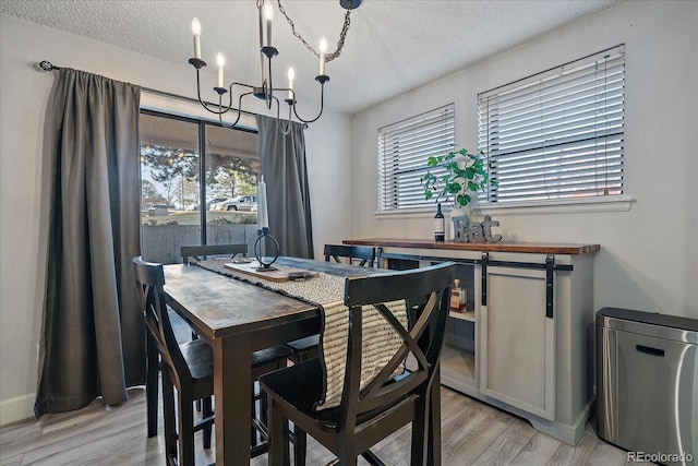 dining room featuring a chandelier, light wood-style flooring, and plenty of natural light