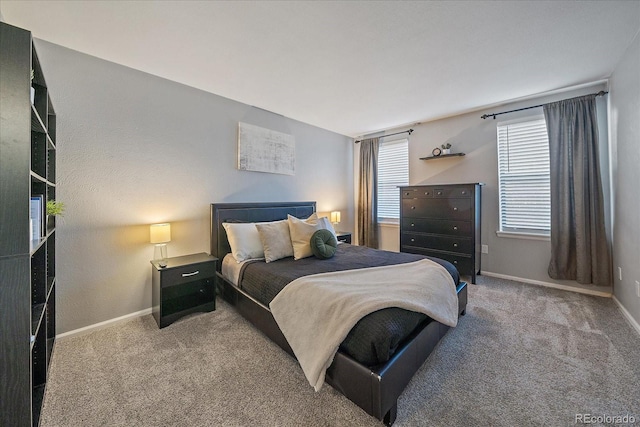 carpeted bedroom featuring baseboards
