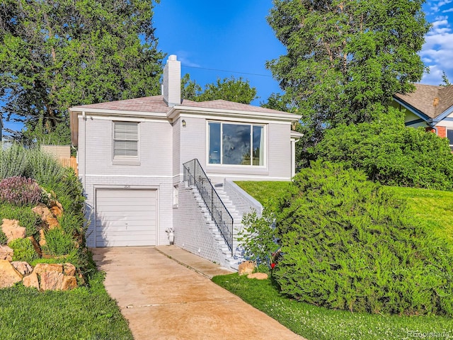 2626 N Steele St, Denver, CO 80205 - single story home featuring an attached garage, a chimney, stairway, concrete driveway, and brick siding