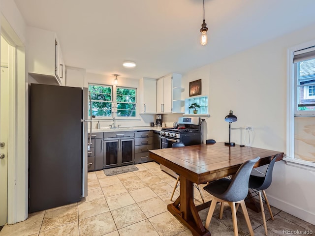 2626 N Steele St, Denver, CO 80205 - kitchen with stainless steel appliances, healthy amount of natural light, white cabinets, and open shelves