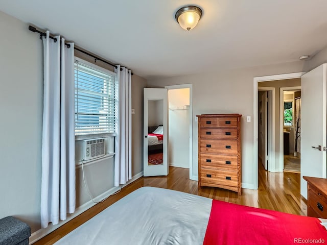 2626 N Steele St, Denver, CO 80205 - bedroom with cooling unit, wood finished floors, and multiple windows