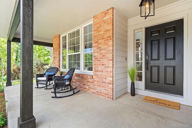 2037 River W Dr, Windsor, CO 80550 - property entrance with a porch and brick siding