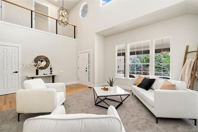 2037 River W Dr, Windsor, CO 80550 - living area featuring a chandelier, wood finished floors, and a towering ceiling