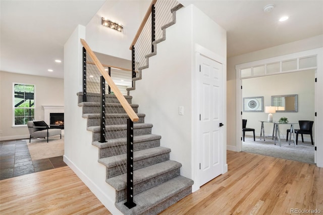 2037 River W Dr, Windsor, CO 80550 - stairway with wood finished floors, a fireplace, and recessed lighting