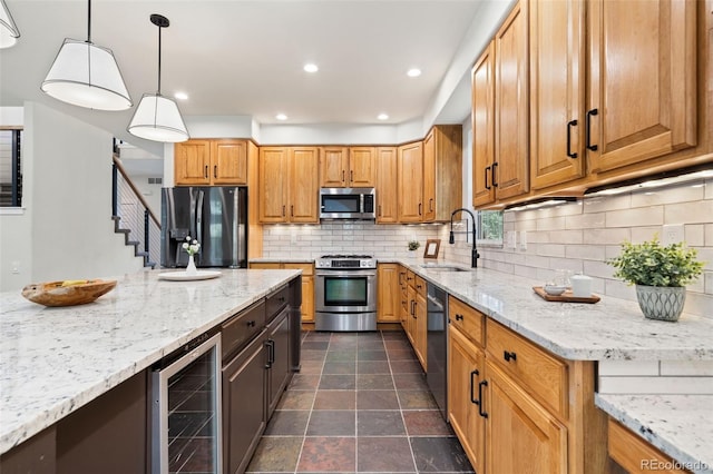 2037 River W Dr, Windsor, CO 80550 - kitchen with stainless steel appliances, wine cooler, light stone countertops, and recessed lighting