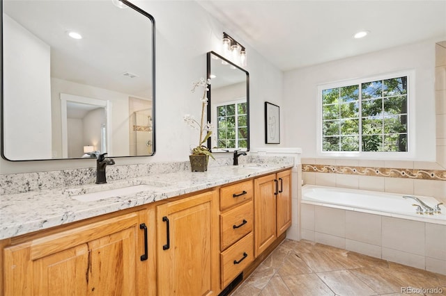 2037 River W Dr, Windsor, CO 80550 - bathroom with double vanity, a garden tub, and recessed lighting