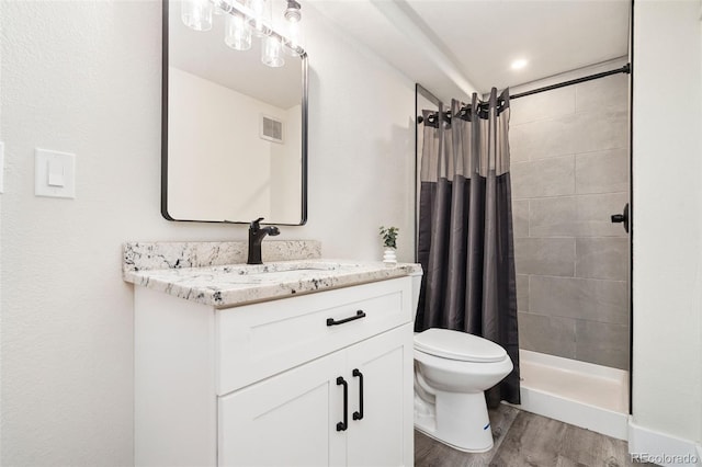 2037 River W Dr, Windsor, CO 80550 - full bath featuring wood finished floors, vanity, and a tile shower