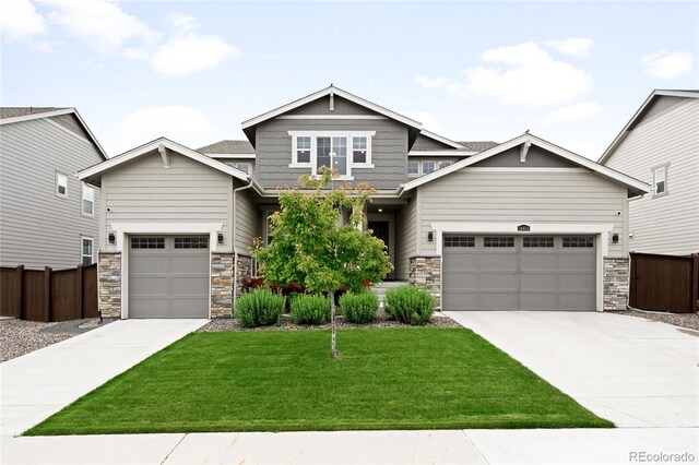 14454 Grape Way, Thornton, CO 80602 - craftsman-style home featuring concrete driveway, stone siding, and an attached garage