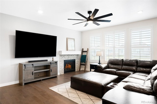 14454 Grape Way, Thornton, CO 80602 - living area featuring a ceiling fan, dark wood finished floors, a tiled fireplace, baseboards, and recessed lighting