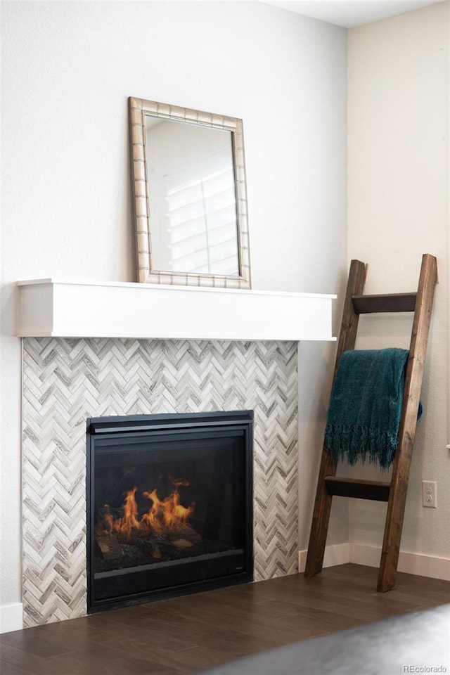 14454 Grape Way, Thornton, CO 80602 - detailed view of a tile fireplace, wood finished floors, and baseboards