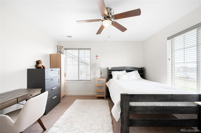 14454 Grape Way, Thornton, CO 80602 - bedroom featuring multiple windows, light colored carpet, baseboards, and ceiling fan