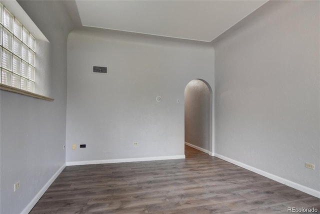 4514 Bryant St, Denver, CO 80211 - unfurnished room with wood finished floors, arched walkways, and baseboards