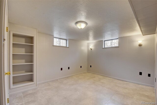 4514 Bryant St, Denver, CO 80211 - below grade area featuring a textured ceiling, built in shelves, and baseboards