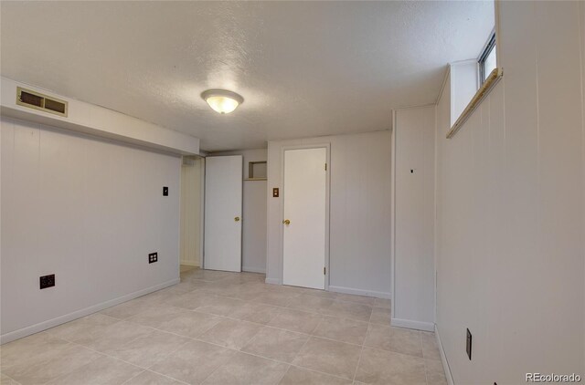 4514 Bryant St, Denver, CO 80211 - spare room with a textured ceiling, baseboards, and light tile patterned floors