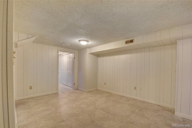 4514 Bryant St, Denver, CO 80211 - finished below grade area with a textured ceiling, wood walls, and baseboards