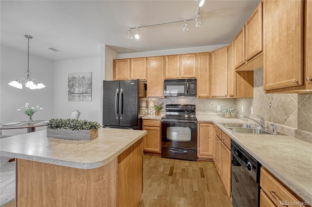 kitchen featuring light brown cabinetry, sink, light hardwood / wood-style flooring, a notable chandelier, and black appliances