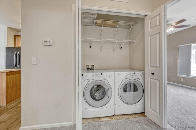 laundry room with separate washer and dryer, light carpet, and ceiling fan