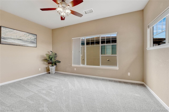 empty room with ceiling fan and carpet floors