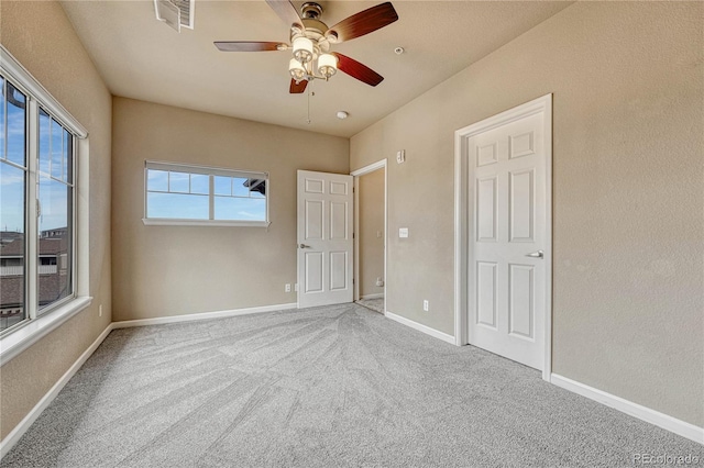 unfurnished bedroom with carpet flooring and ceiling fan