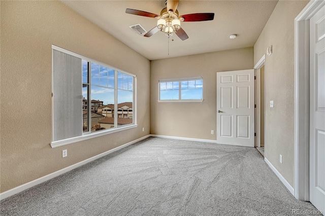 carpeted spare room with ceiling fan