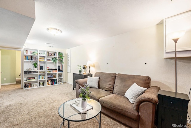 living room featuring carpet floors and a textured ceiling